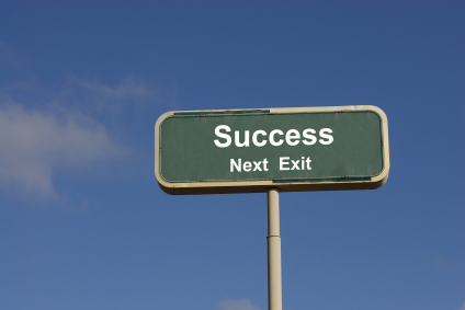 road sign that says success next exit