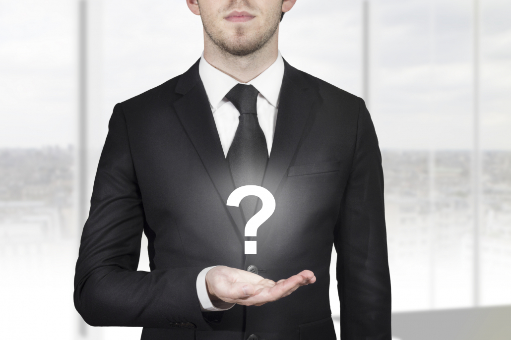 businessman holding question mark - Think Transition