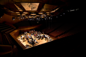 orchestra practising in empty concert hall