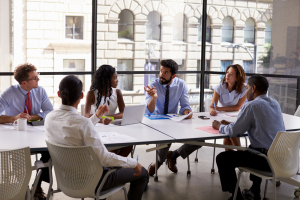 diverse group of people sitting around conference table